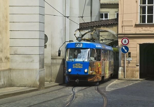 Tram come out from arch under buildings in old town, Prague, Czech Republic