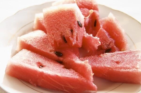 Triangular pieces of red water melon Shalqi on a white plate. Berat lower town. Albania