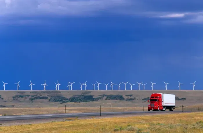 Framed Print : A truck traveling on the highway with a row of windmills in the background in Arlington Framed Print : A truck traveling on the highway with a row of windmills in the background in Arlington