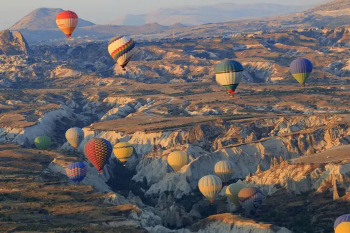 Framed Print : Turkey, Anatolia, Cappadocia, Goreme. Hot air balloons flying above  /  among rock formations
