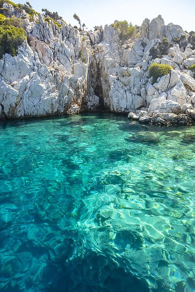 Turquoise colored crystal clear water at a rocky island, Aegean Sea, Turkey
