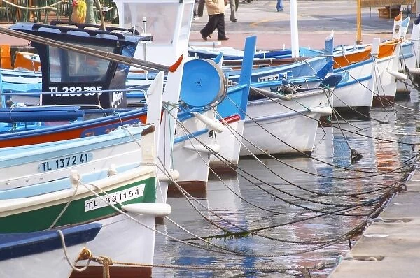 Typical Provencal fishing boats painted in bright colours white, blue, green red yellow