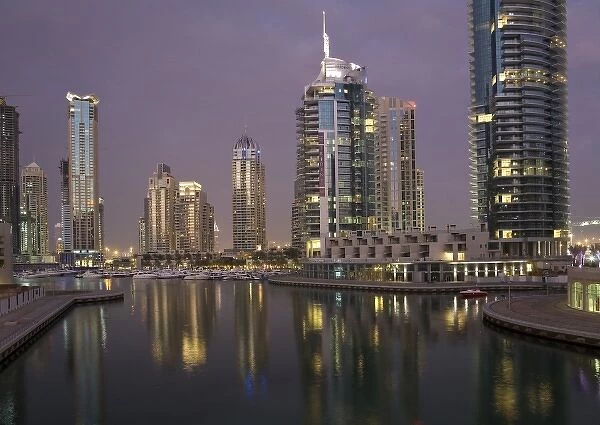 UAE, Dubai, Marina. Tower lights reflect on marina water at night