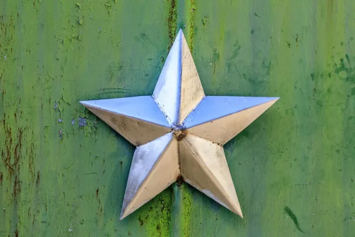 Framed Print : Ukraine, Pripyat, Chernobyl. Decorative silver Soviet star on a green wall