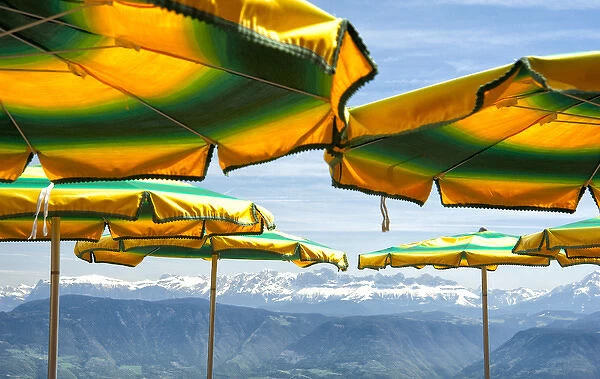 Umbrellas from a mountain top cafe overlooking the alps in Italy