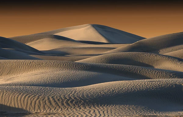Undulating sand dunes of Death Valley in golden light