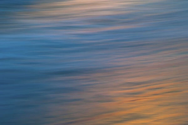 Undulating waves reflecting the sunset colors