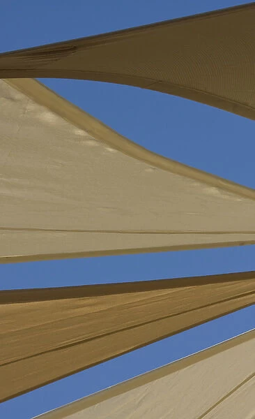 United Arab Emirates, Fujairah. Sand-colored canvas awnings under blue sky. Credit as