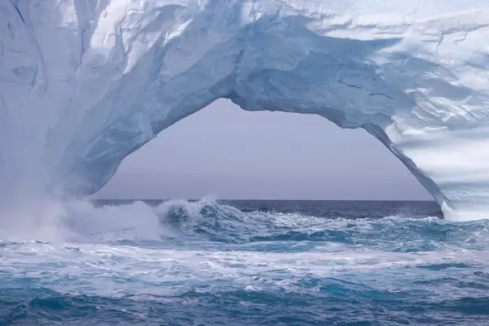 Framed Print : United Kingdom Territory, South Georgia Island. Waves splash under iceberg arch. Credit as Framed Print : United Kingdom Territory, South Georgia Island. Waves splash under iceberg arch. Credit as
