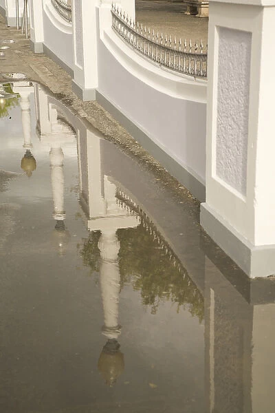 United States, Puerto Rico, Ponce. Reflection of lamp posts in puddle, Plaza Las Delicias