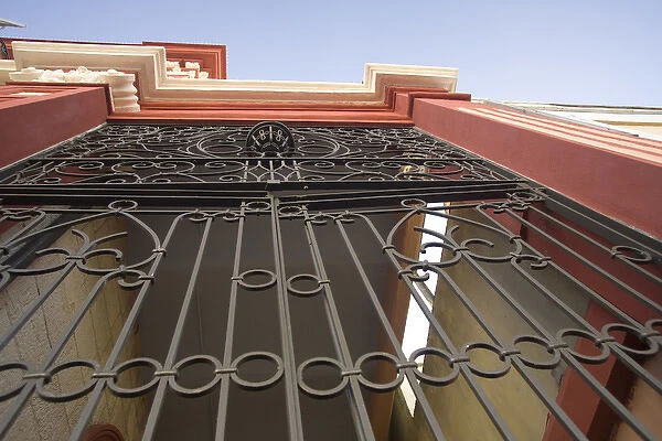 United States, Puerto Rico, Ponce. Traditional colonial architecture with wrought-iron gate