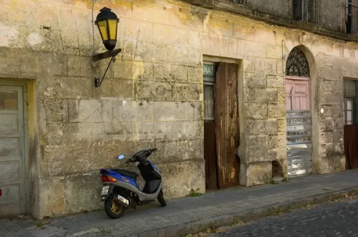 Framed Print : Uruguay. Colonia del Sacramento. Barrio Historico. Scooter outside an abandoned building Framed Print : Uruguay. Colonia del Sacramento. Barrio Historico. Scooter outside an abandoned building