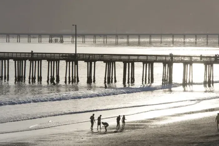 Framed Print : US, CA, Avila Beach. Silhouetted beach walkers approach pier end of day Framed Print : US, CA, Avila Beach. Silhouetted beach walkers approach pier end of day