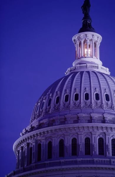 U.s Capitol at dusk with light in dome on showing that Congress is in session