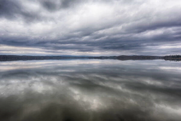 US, TN, Ten Mile. Calm before the storm. Storm clouds reflected in glass calm lake