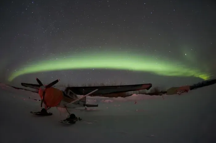 Framed Print : USA, Alasaka, Bettles. An airplane waits out the night beneath the northern lights