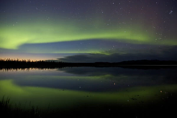 USA, Alaska, Bettles. Aurora borealis reflects in Vor Lake Waterlane