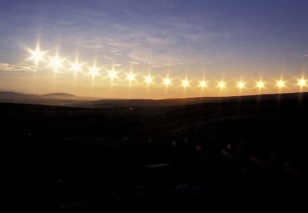 USA, Alaska, Brooks Range. Multiple exposure image of midnight sun