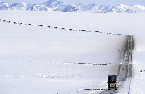 USA, Alaska, Brooks Range. Truck drives on the ice covered haul road to Prudhoe Bay