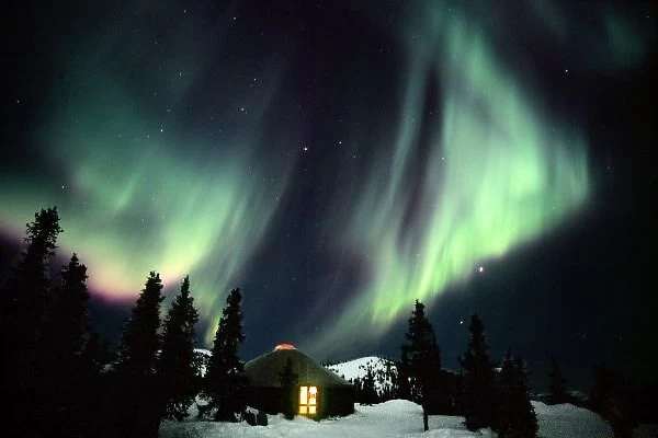 USA, Alaska, Chena Hot Springs. Aurora Borealis in the night sky above a yurt