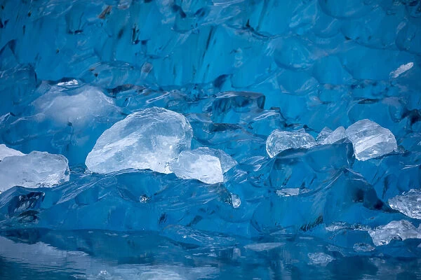 USA, Alaska, Close-up view of deep blue iceberg floating near calving face of LeConte