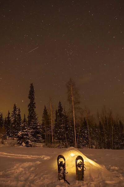 USA, Alaska, Fairbanks. A quinzee snow shelter under the night sky
