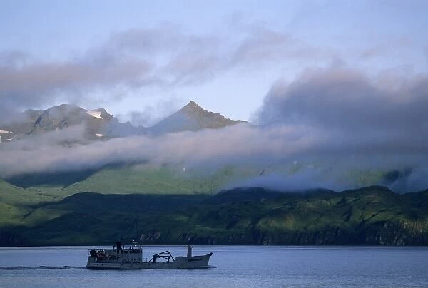USA, Alaska, fishing boat sails out of Dutch Harbor, Unalaska Island, Aleutian Islands