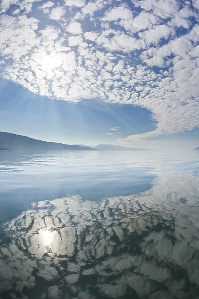 USA, Alaska, Freshwater Bay. Clouds reflected in water