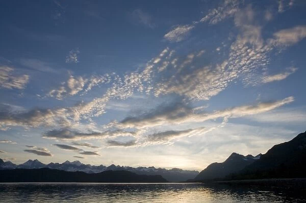 USA, Alaska, Glacier Bay National Park, Setting sun lights clouds above Fairweather Range