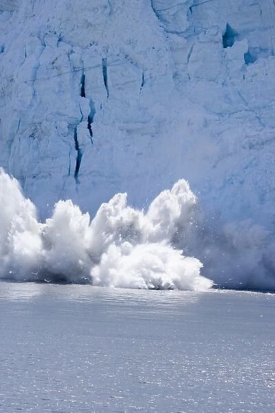 USA, Alaska, Glacier Bay National Park. Ice calving off face of Great Plain Glacier