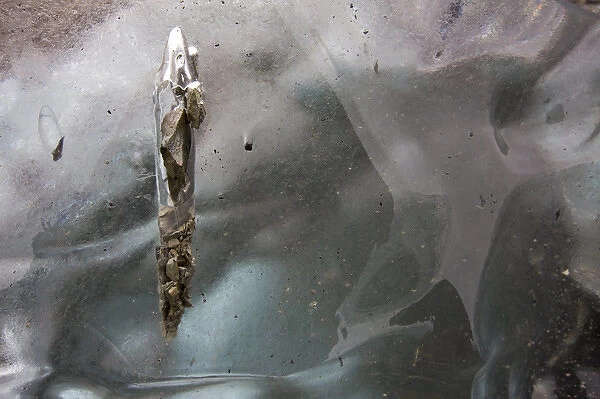 USA, Alaska, Detail of gravel melting into surface of iceberg grounded along Prince