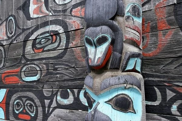 USA; Alaska, Haines. Partial view of Native-American totem pole and wall mural