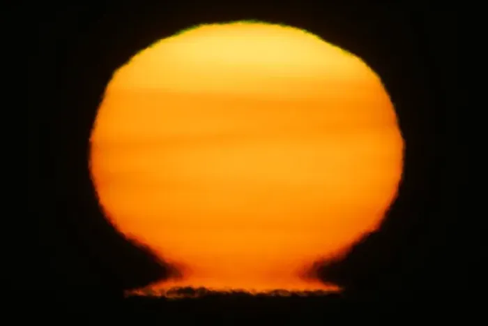 Framed Print : USA, Alaska, Homer. Sun at sunset distorts to look like a nuclear fireball. Credit as Framed Print : USA, Alaska, Homer. Sun at sunset distorts to look like a nuclear fireball. Credit as