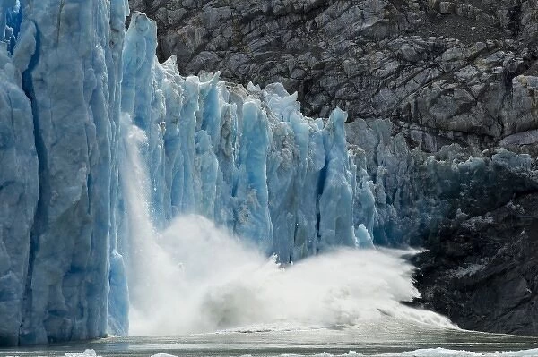 USA, Alaska, Massive icebergs calving from blue ice face of Dawes Glacier in Endicott