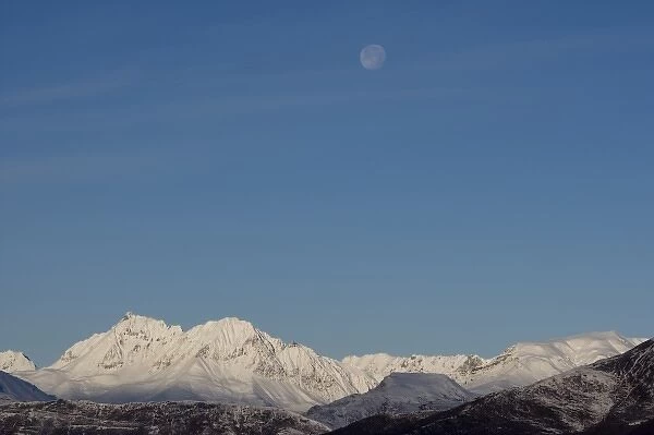 USA, Alaska, Full moon above Chugach Range mountain peaks in early winter