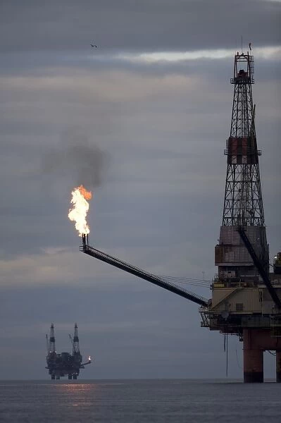 USA, Alaska, Offshore oil drilling rigs with burning natural gas flares in Cook Inlet