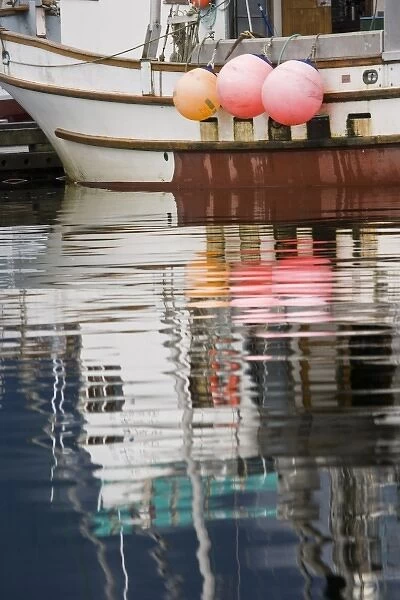 USA, Alaska, Petersburg. Fishing boats reflect in water of harbor