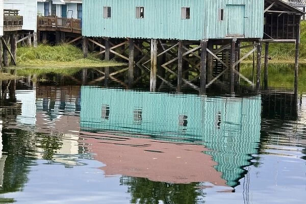 USA, Alaska, Petersburg. Water reflections of buildings in Hammer Slough