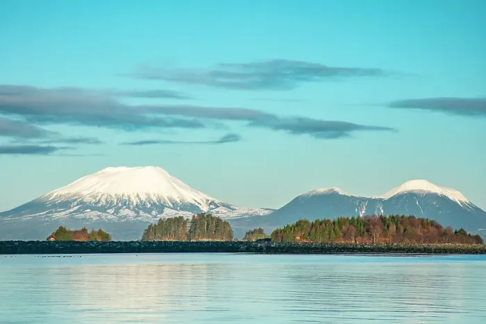 Framed Print : USA, Alaska, Sitka. Snow-covered Mt. Edgecumbe volcano and rock barrier on shore. ©Cathy & Gordon Illg  /  Jaynes Gallery  /  DanitaDelimont.com