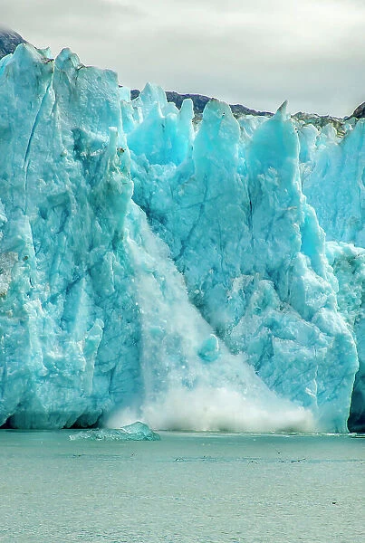 USA, Alaska, Tongass National Forest. Dawes Glacier calving in Endicott Arm water