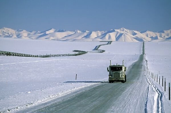 USA, Alaska. Truck on the Dalton Highway, next to the Trans-Alaskan Pipeline