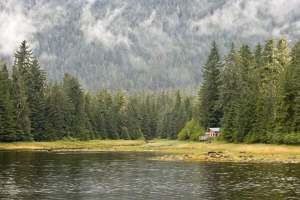USA, Alaska, Wrangel. Isolated cabin at edge of forest and lake