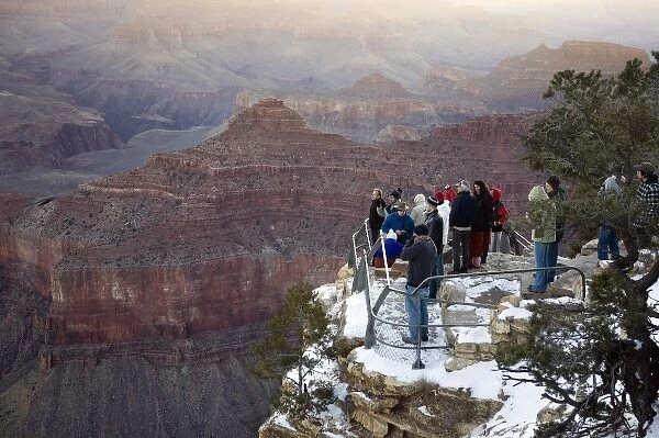 USA, Arizona, Grand Canyon National Park. Visitors at Yavapai Point for sunrise in winter
