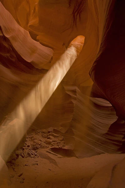 USA, Arizona, Lower Antelope Canyon. Sunbeam penetrates dusty air of canyon. Credit as