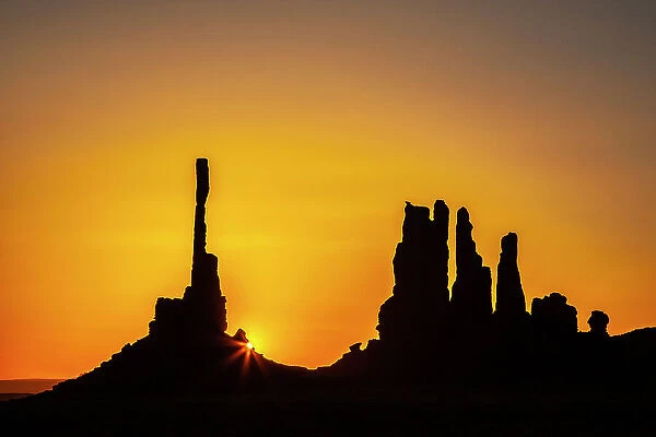 USA, Arizona, Monument Valley Navajo Tribal Park. Silhouette of formations at sunrise