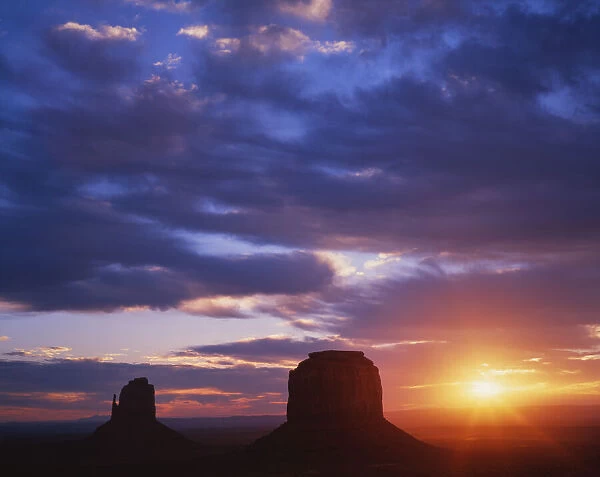 USA, Arizona, Monument Valley. Sunrise silhouettes of formations