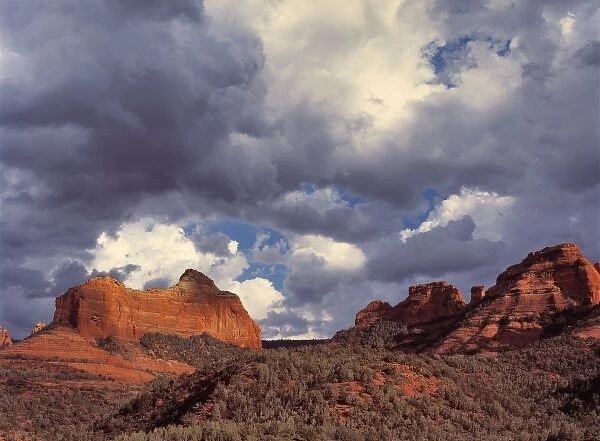 USA, Arizona, Oak Creek Canyon. Dramatic storm clouds gather behind the red rocks
