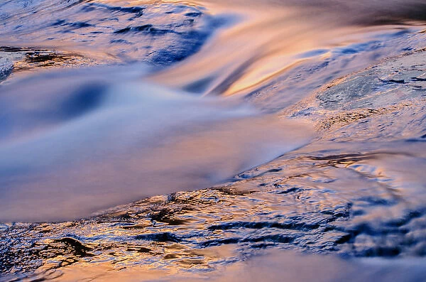 USA, Arizona, Sedona. Reflections on water flowing over rock