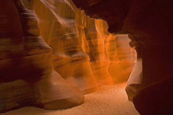 USA, Arizona, Upper Antelope Canyon. Slot canyons glowing wall and sandy floor