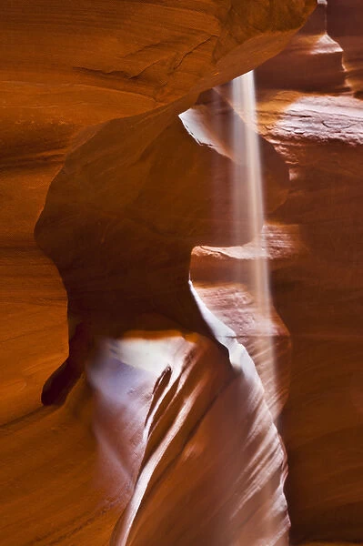 USA, Arizona, Upper Antelope Canyon. Falling sand mimics light ray amid sandstone formation